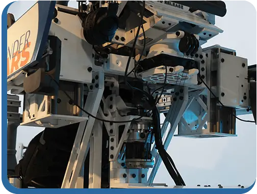 A close up shot of the back of the machine, showing advanced robotics on the platform